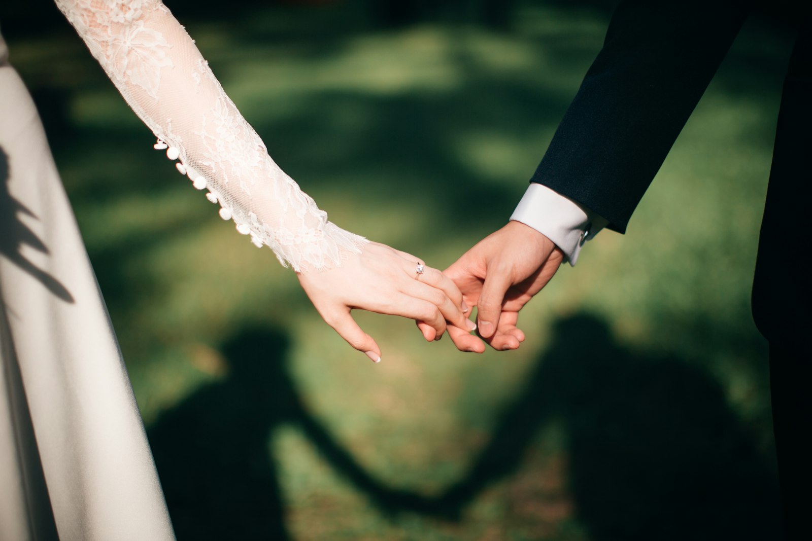 The couple hand in hand, through their photographer's lens